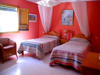 photo of one of the red bedrooms of the finca